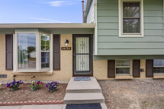 16135 E Baker Pl, Aurora, CO 80013 - doorway to property featuring brick siding