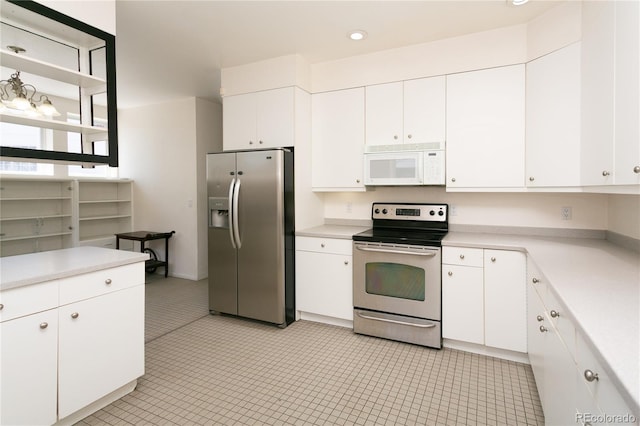 kitchen with white cabinets and appliances with stainless steel finishes