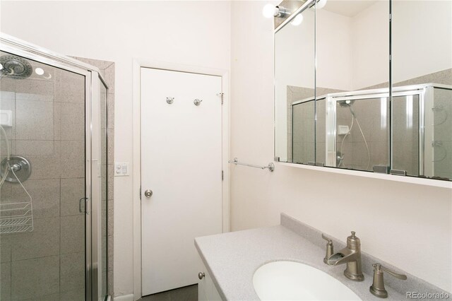 bathroom featuring vanity and a shower with shower door