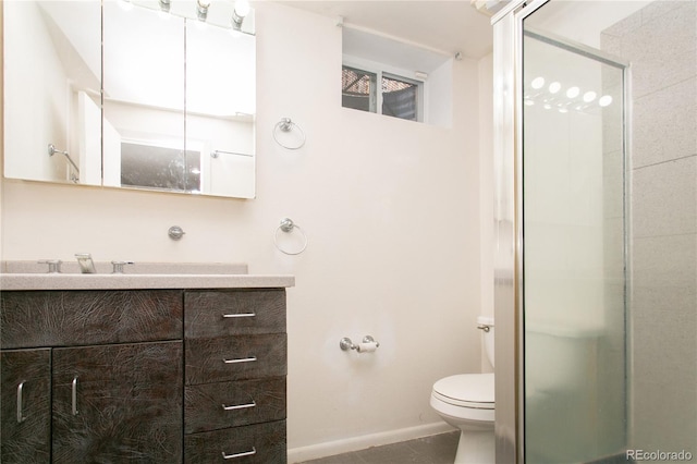 bathroom featuring tile patterned floors, vanity, toilet, and an enclosed shower