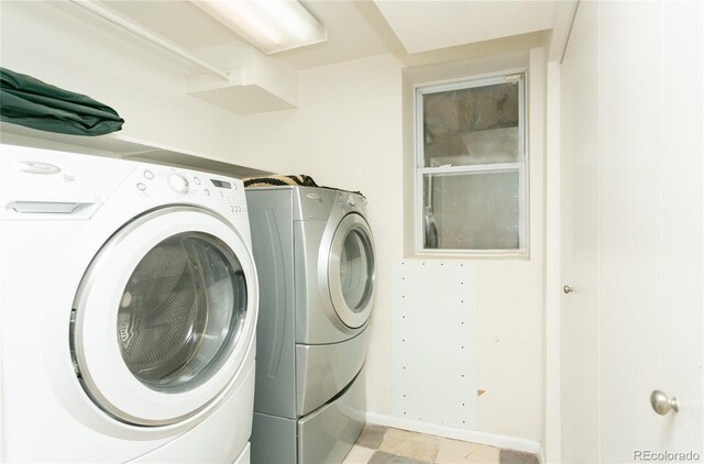 clothes washing area with washing machine and dryer