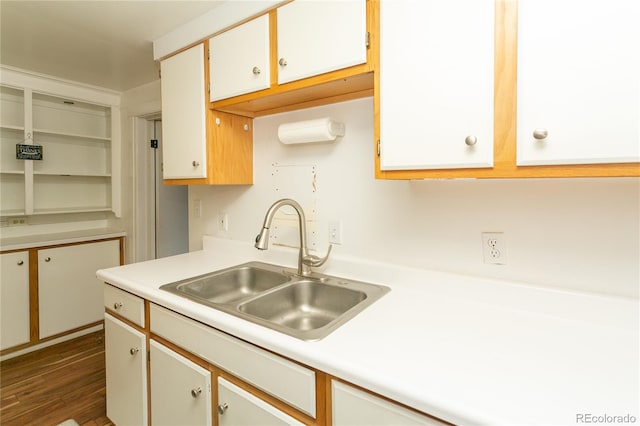 kitchen with white cabinets, dark hardwood / wood-style floors, and sink