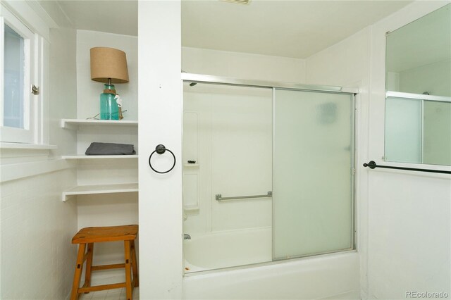 bathroom featuring shower / bath combination with glass door