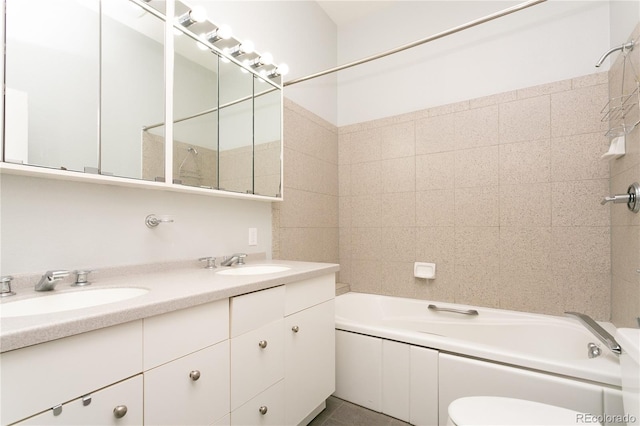 full bathroom with vanity, tiled shower / bath combo, and toilet