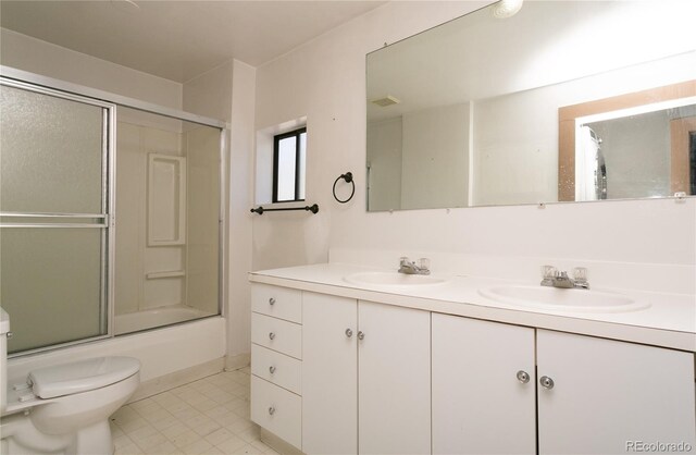 full bathroom with toilet, vanity, and combined bath / shower with glass door