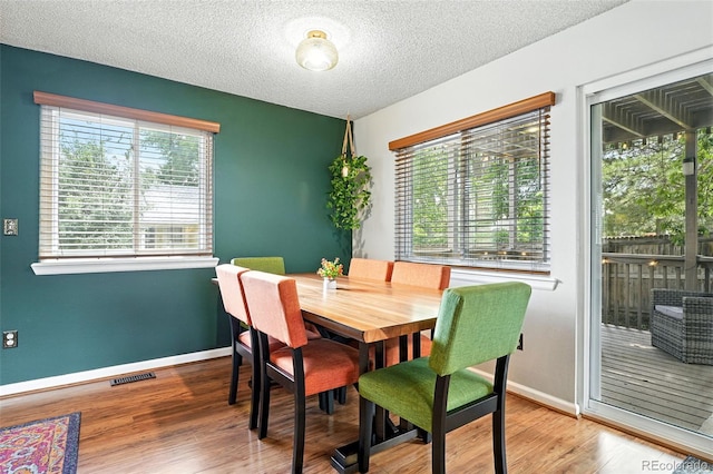 8468 S Upham Way, Littleton, CO 80128 - dining area with wood finished floors and a textured ceiling