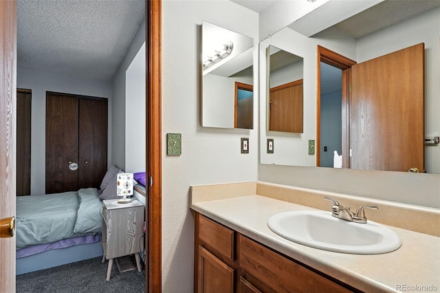 8468 S Upham Way, Littleton, CO 80128 - ensuite bathroom featuring vanity and a textured ceiling
