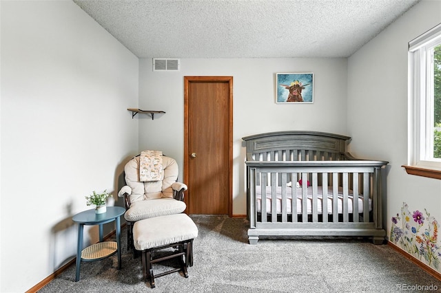8468 S Upham Way, Littleton, CO 80128 - carpeted bedroom with a textured ceiling, multiple windows, and a nursery area