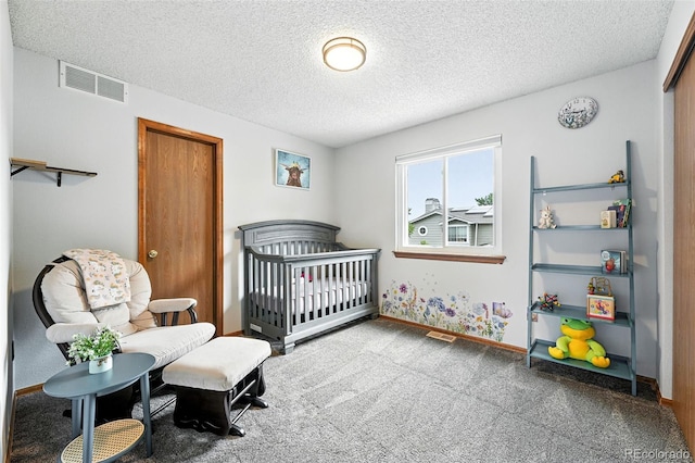 8468 S Upham Way, Littleton, CO 80128 - bedroom featuring a textured ceiling, carpet flooring, and a nursery area