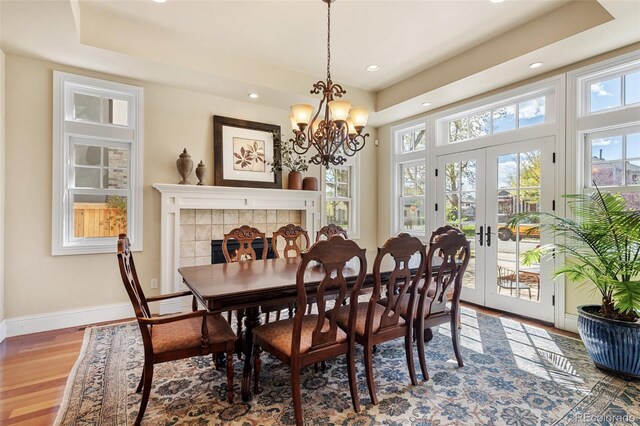 dining space featuring recessed lighting, baseboards, french doors, and light wood-type flooring