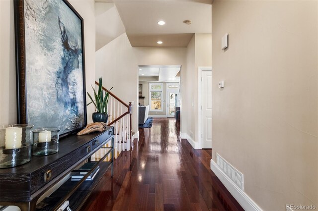 hall with baseboards, recessed lighting, wood finished floors, and visible vents