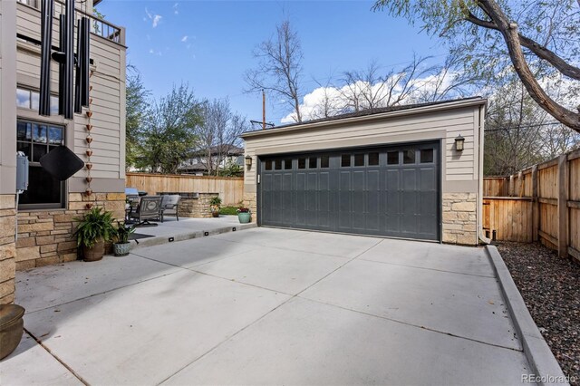 detached garage featuring fence