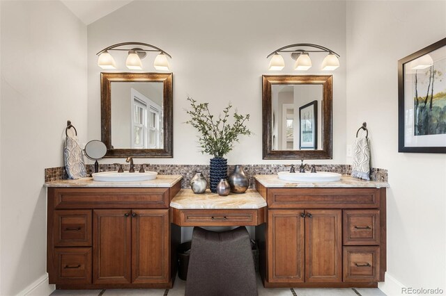 full bathroom with baseboards, lofted ceiling, and vanity