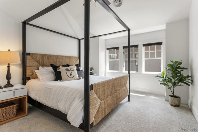 carpeted bedroom with baseboards and visible vents