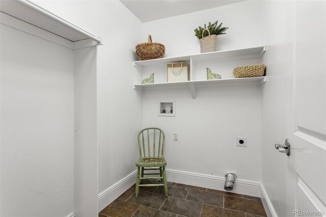 laundry area featuring stone finish floor, laundry area, electric dryer hookup, baseboards, and hookup for a washing machine