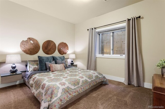 carpeted bedroom featuring baseboards