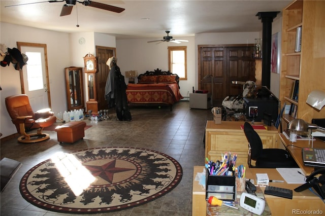 bedroom with dark tile patterned floors and a wood stove