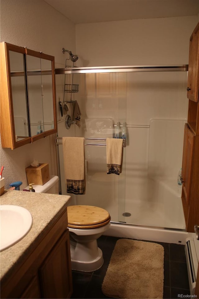 bathroom with toilet, tile patterned floors, an enclosed shower, a baseboard radiator, and vanity