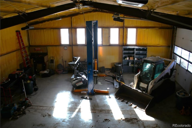 garage with a garage door opener and wooden walls