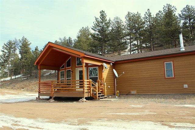 back of property featuring a wooden deck