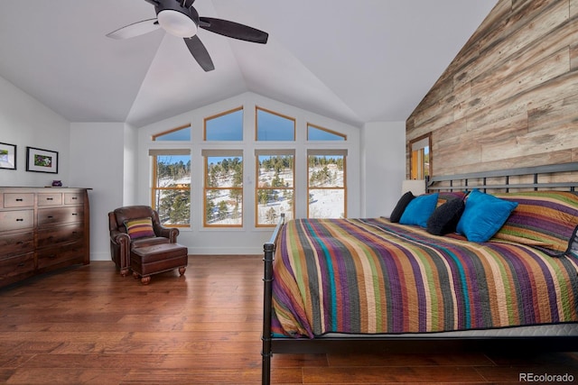 bedroom with ceiling fan, vaulted ceiling, and wood finished floors