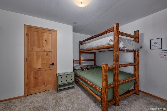 bedroom with carpet flooring and baseboards