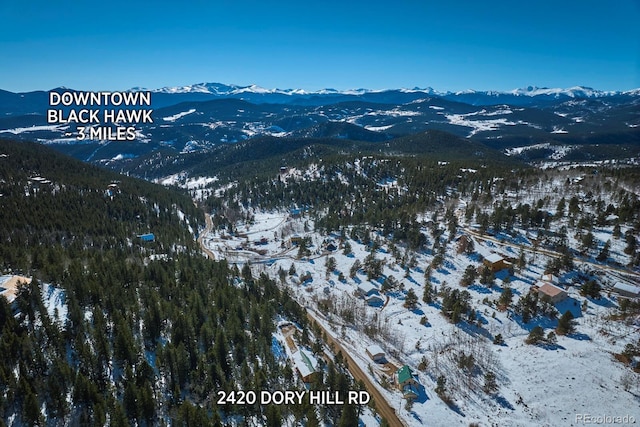 snowy aerial view featuring a mountain view