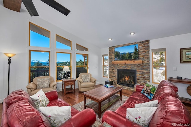 living room with recessed lighting, a fireplace, and wood finished floors