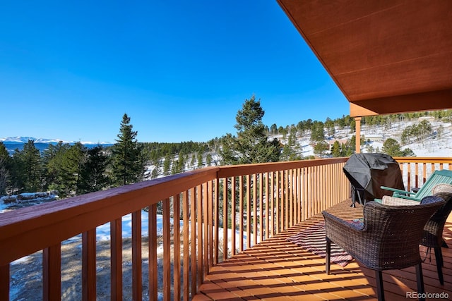 wooden terrace with grilling area and a mountain view