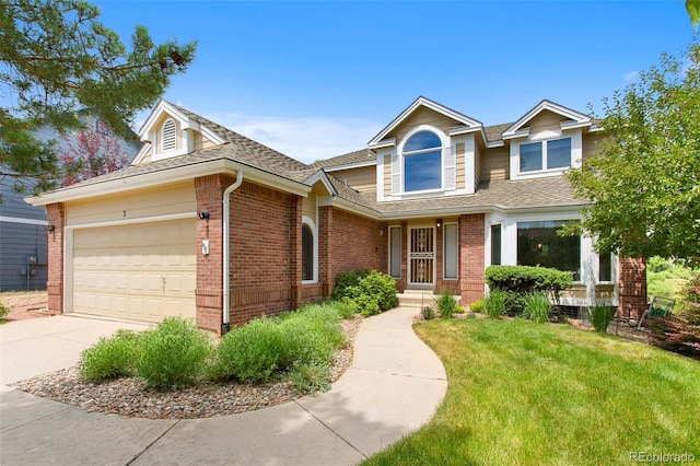 3 Silverberry, Littleton, CO 80127 - view of front of property with brick siding, a garage, a front yard, concrete driveway, and roof with shingles