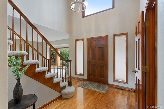 3 Silverberry, Littleton, CO 80127 - foyer featuring stairway, wood finished floors, a chandelier, and a high ceiling