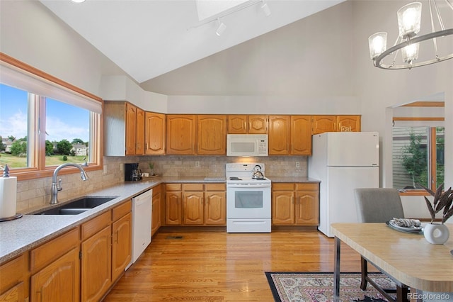 3 Silverberry, Littleton, CO 80127 - kitchen featuring white appliances, high vaulted ceiling, healthy amount of natural light, a chandelier, and light countertops