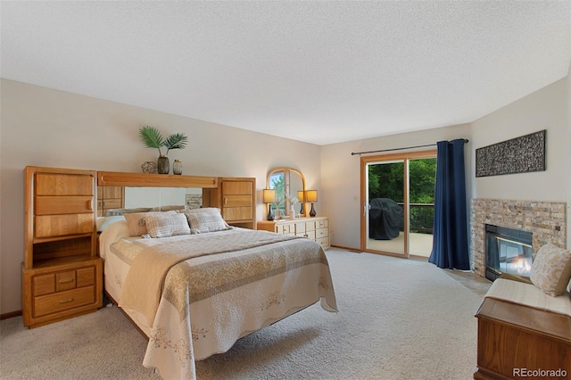 3 Silverberry, Littleton, CO 80127 - bedroom featuring access to outside, light carpet, and a stone fireplace