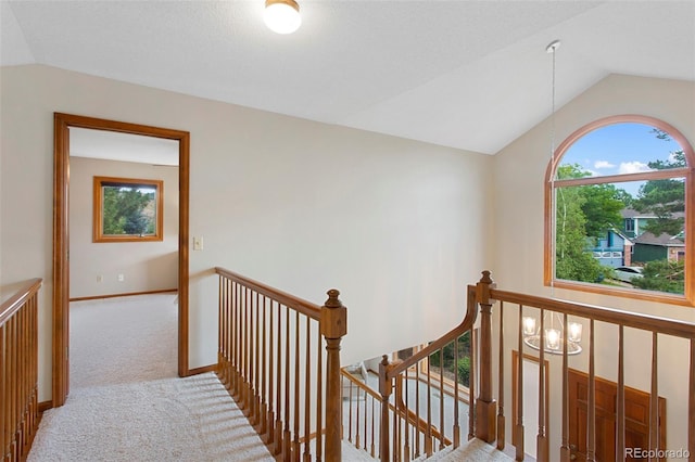 3 Silverberry, Littleton, CO 80127 - hall with an upstairs landing, vaulted ceiling, and carpet floors