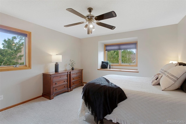 3 Silverberry, Littleton, CO 80127 - bedroom with multiple windows, light colored carpet, and ceiling fan