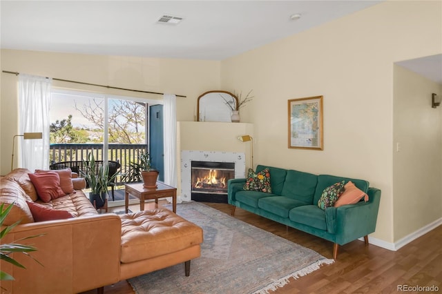 8405 Pebble Creek Way Unit 202, Highlands Ranch, CO 80126 - living area with wood finished floors, a fireplace, and baseboards