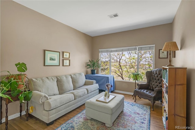 8405 Pebble Creek Way Unit 202, Highlands Ranch, CO 80126 - living room featuring wood finished floors and baseboards