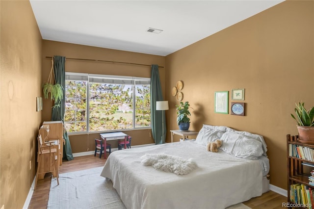 8405 Pebble Creek Way Unit 202, Highlands Ranch, CO 80126 - bedroom with wood finished floors and baseboards