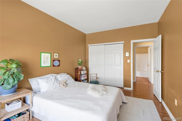 8405 Pebble Creek Way Unit 202, Highlands Ranch, CO 80126 - bedroom featuring wood finished floors, baseboards, and a closet
