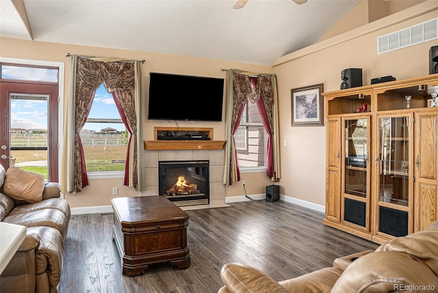 29751 E 163rd Pl, Brighton, CO 80603 - living area featuring vaulted ceiling, baseboards, a tiled fireplace, visible vents, and wood finished floors
