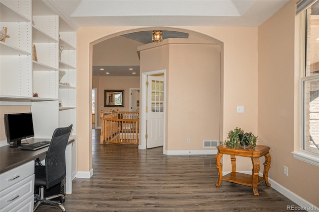 29751 E 163rd Pl, Brighton, CO 80603 - office space featuring arched walkways, baseboards, visible vents, and dark wood-type flooring