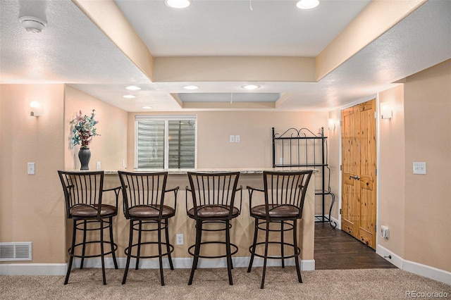 29751 E 163rd Pl, Brighton, CO 80603 - bar with carpet floors, a raised ceiling, baseboards, and visible vents