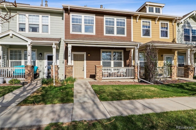 15612 E 96th Way Unit 13E, Commerce City, CO 80022 - townhome / multi-family property with a porch and stone siding