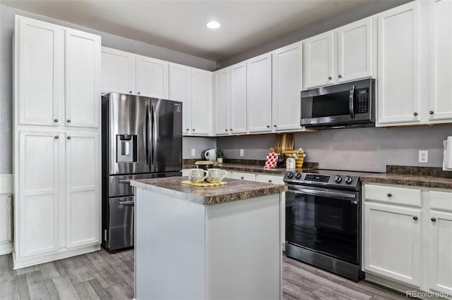 15612 E 96th Way Unit 13E, Commerce City, CO 80022 - kitchen with appliances with stainless steel finishes, dark countertops, light wood-style flooring, and recessed lighting