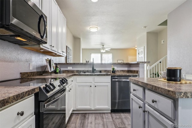 15612 E 96th Way Unit 13E, Commerce City, CO 80022 - kitchen featuring black range with electric cooktop, dishwasher, a sink, dark countertops, and ceiling fan