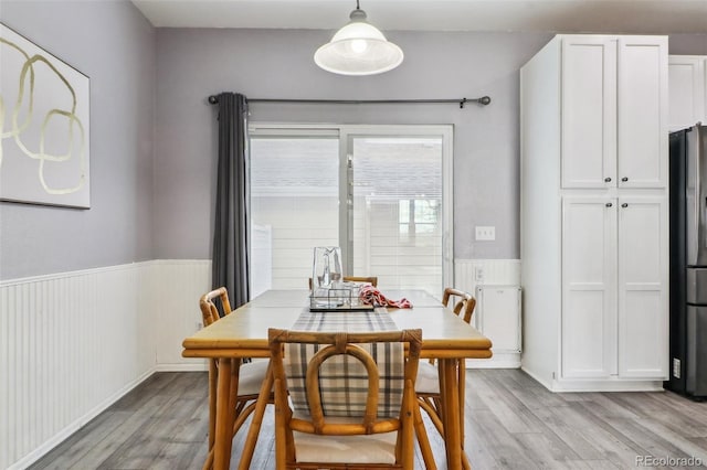 15612 E 96th Way Unit 13E, Commerce City, CO 80022 - dining room with light wood finished floors and wainscoting