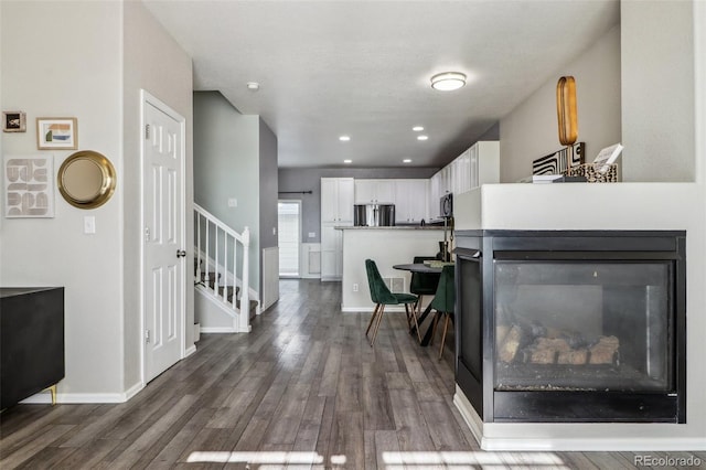15612 E 96th Way Unit 13E, Commerce City, CO 80022 - living room with stairs, wood finished floors, and baseboards
