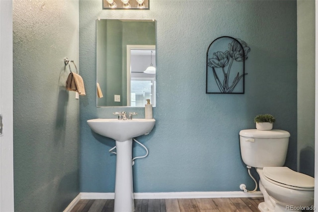 15612 E 96th Way Unit 13E, Commerce City, CO 80022 - half bath featuring toilet, wood finished floors, and baseboards