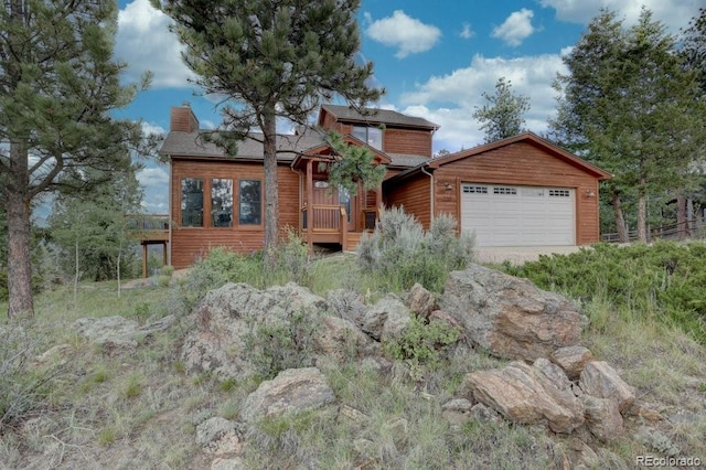 220 Long Ridge Dr, Bailey, CO 80421 - rustic home with a chimney and an attached garage