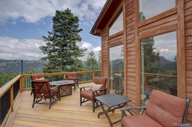 220 Long Ridge Dr, Bailey, CO 80421 - wooden deck with an outdoor fire pit and a mountain view